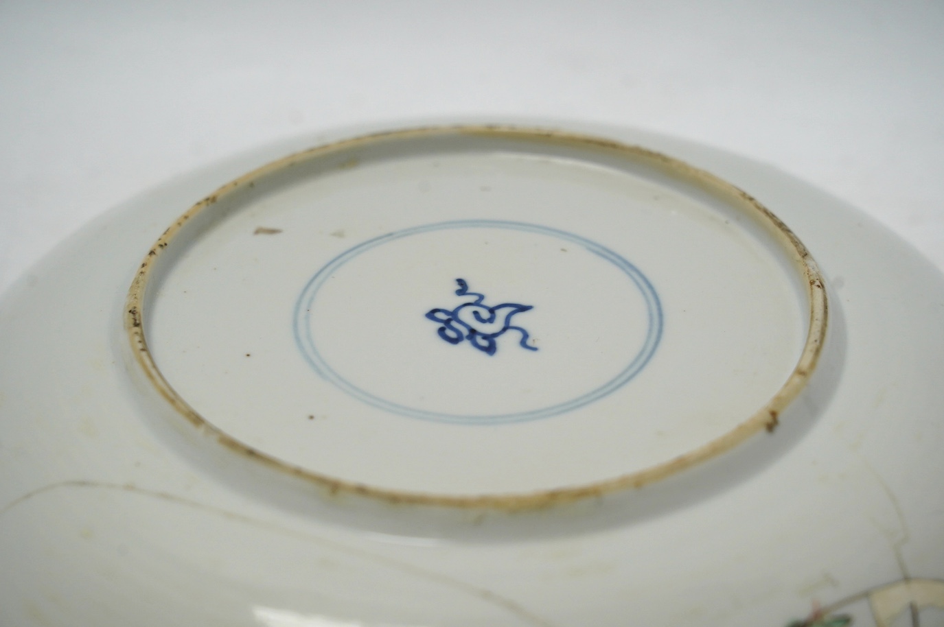A Chinese powder blue famille verte dish, Kangxi period, a Yongzheng Imari plate and a Kangxi blue and white saucer, largest 22cm diameter. Condition - poor
